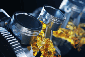auto lube services. Auto repair shop in Republic, MO. Yocum Automotive. Image of engine pistons and gears lubricated with oil, emphasizing the importance of proper engine maintenance for long-term performance and protection.