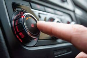 car heater. Auto repair shop in Republic, MO. Yocum Automotive. A person’s finger pressing the heated seat control knob on a car dashboard.