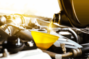 Oil & Lube Services. Auto repair shop in Republic, MO. Yocum Automotive. Motor oil being poured into a car engine through a yellow funnel, symbolizing oil and lube services to prepare a vehicle for winter driving in Republic, Missouri.