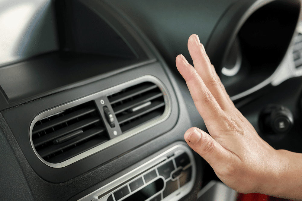 Auto AC Service in Republic, MO by Yocum Automotive, a hand checking for airflow from a car's AC